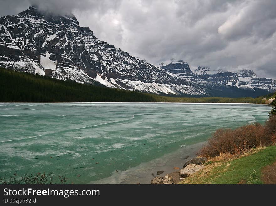 Frozen mountain lake under stormy clouds. Frozen mountain lake under stormy clouds.