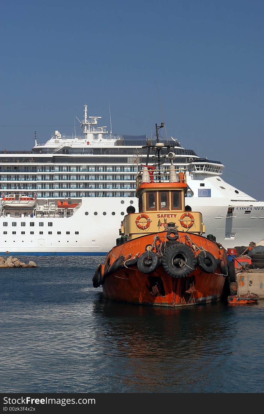 A big modern and small old ship in port. A big modern and small old ship in port