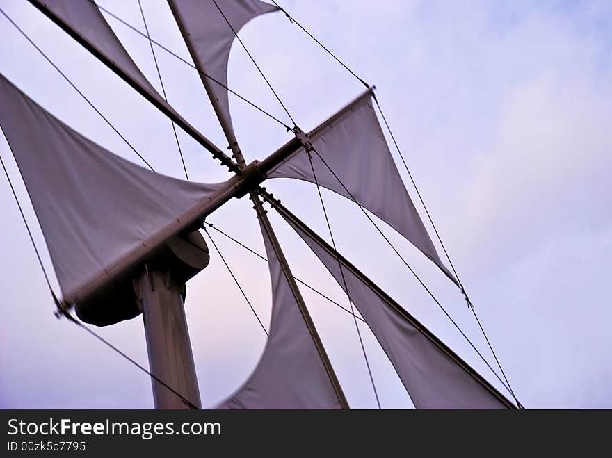 A windmill with white sails. A windmill with white sails