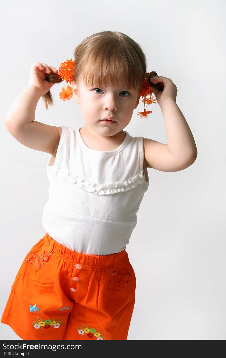 Portrait of little beautiful girl, holding hands in her hair. Portrait of little beautiful girl, holding hands in her hair.