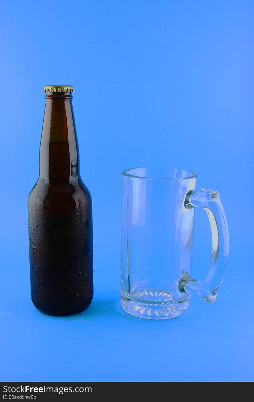 A bottle of beer and a beer mug in blue background.