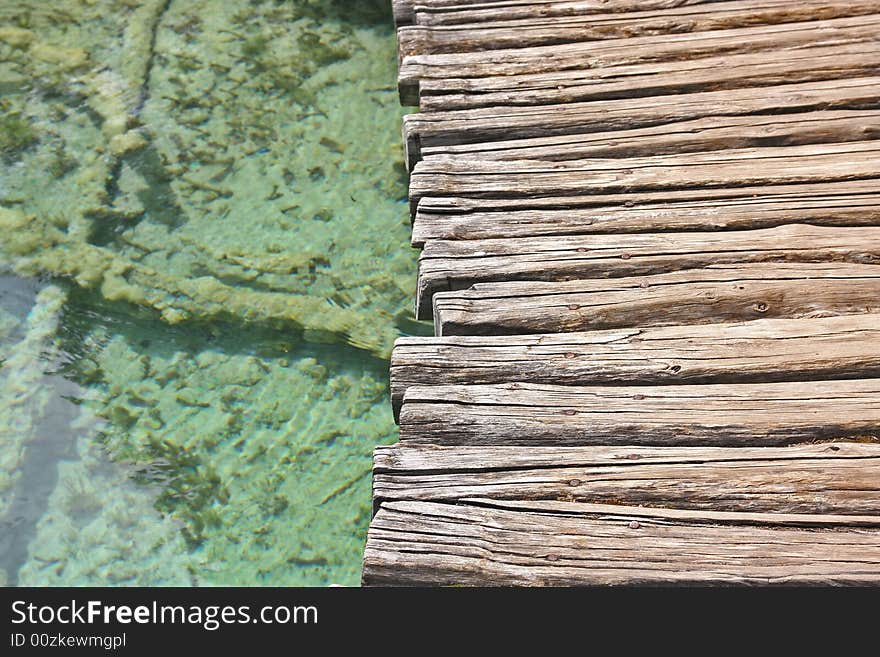 Wooden bridge and green water