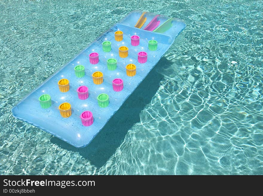 Colorful raft floating in swimming pool, horizontal