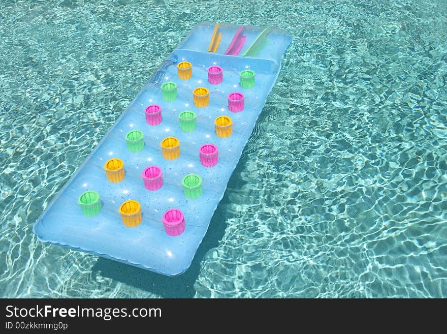 Colorful pool toy floating in water. Colorful pool toy floating in water