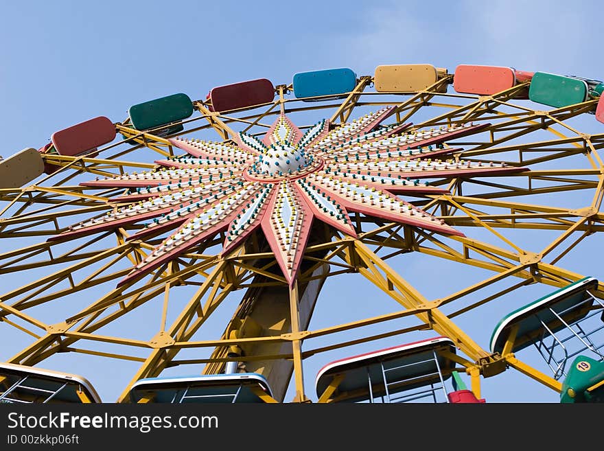 A colorful ferris wheel in an amusement park, beijing, china.