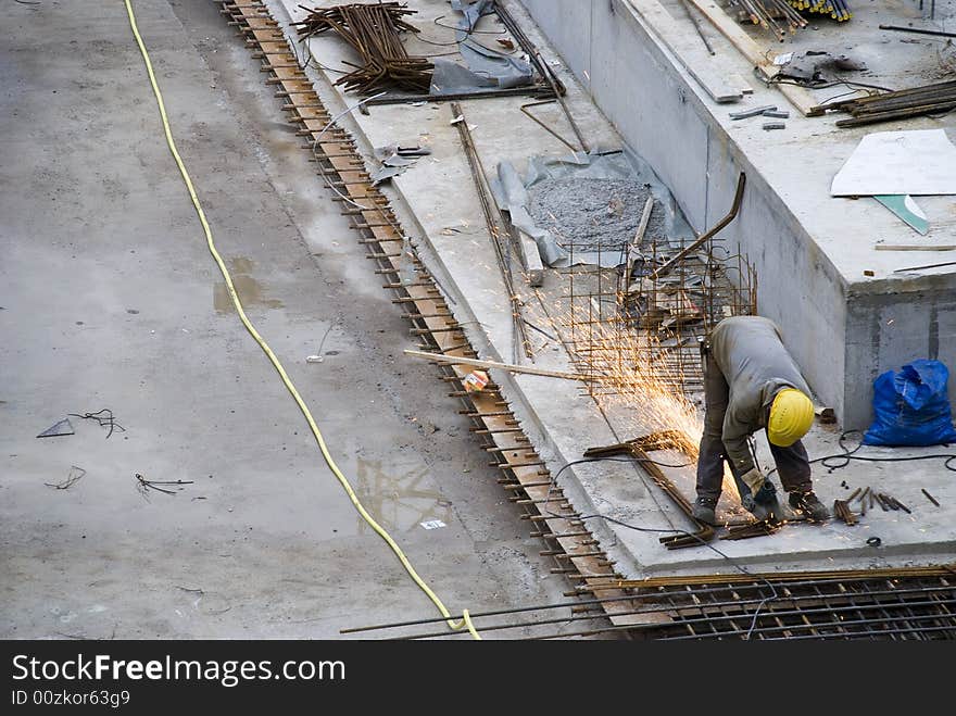 Steel worker is cutting iron