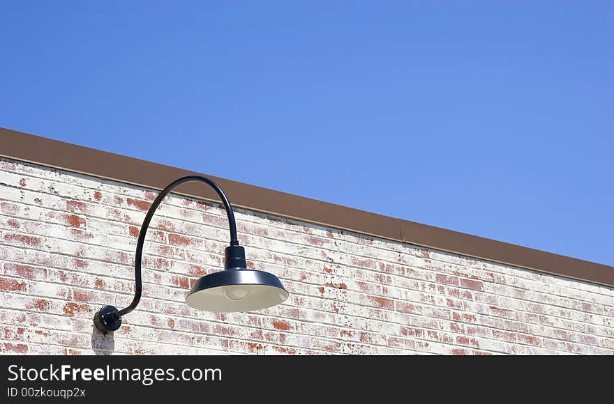 An old fashioned street light on an old brick wall. An old fashioned street light on an old brick wall