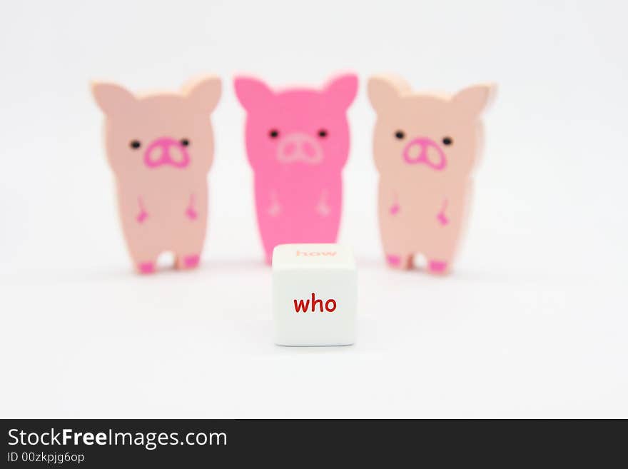 Wooded pig toys looking at a dice written who. Wooded pig toys looking at a dice written who