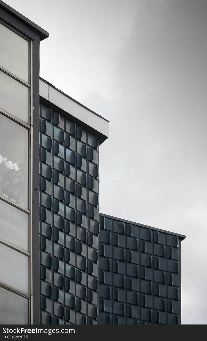 Three buildings in the grey sky