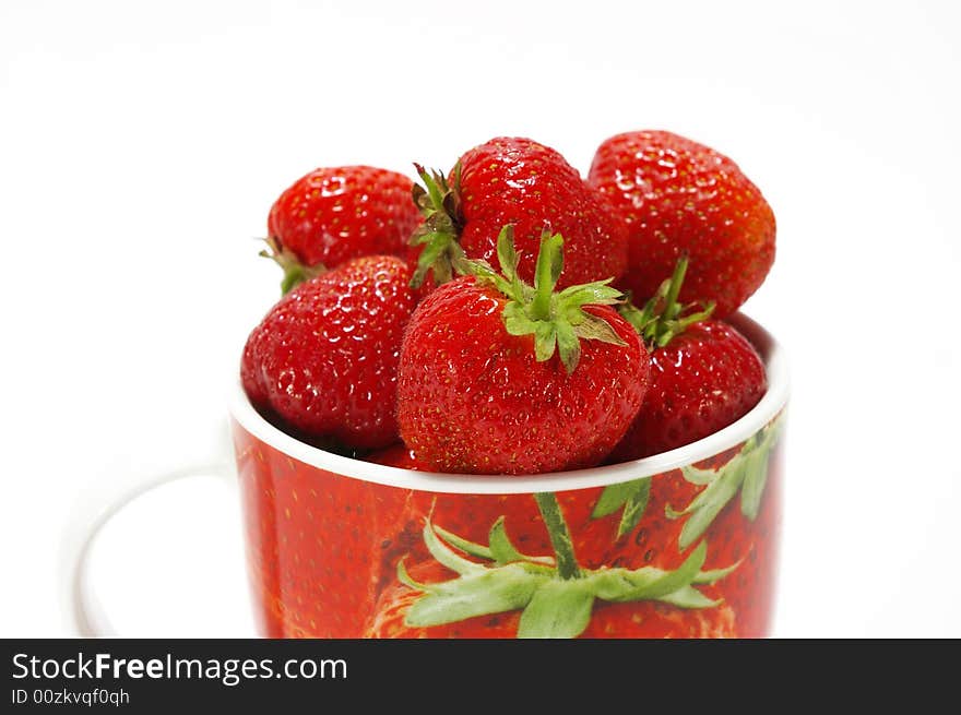 Ripe strawberry in the cup isolated on white background