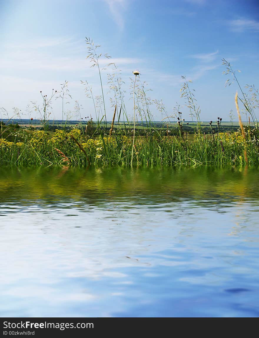 Reflection in a beautiful lake on bright summers day