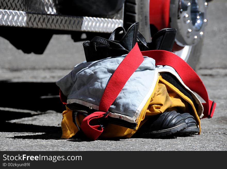 Firefighter pants and boots by firetruck. Firefighter pants and boots by firetruck