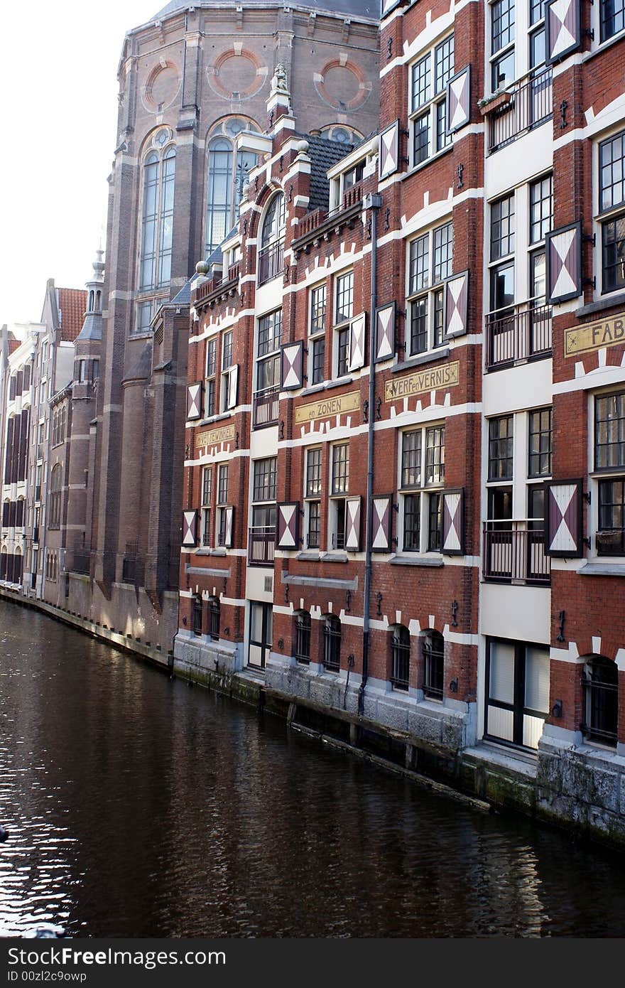 Picture of canal and historic industrial building in Amsterdam, The Netherlands. Picture of canal and historic industrial building in Amsterdam, The Netherlands.