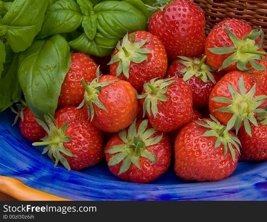 Strawberries on blue plate.