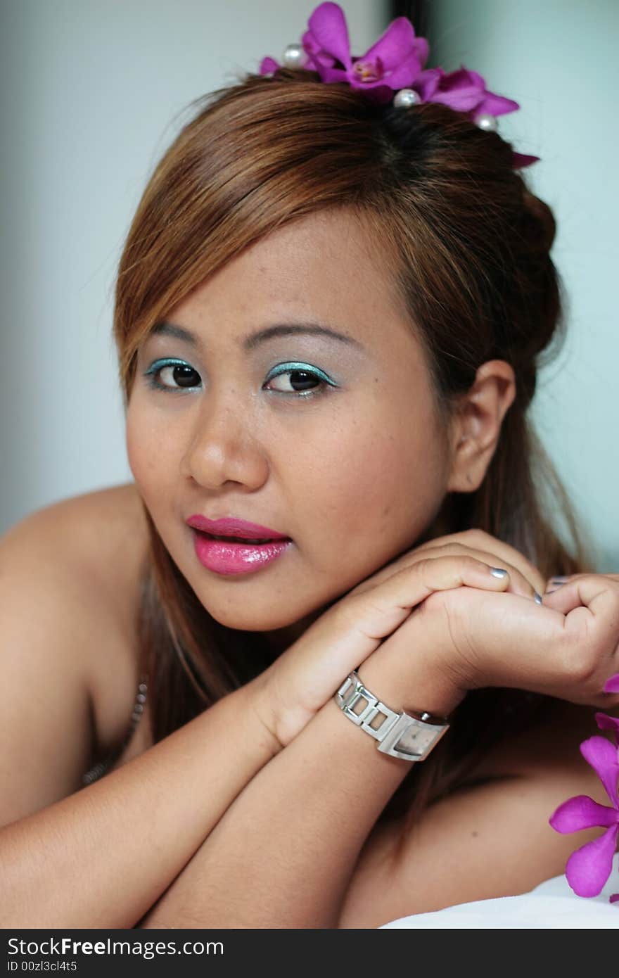 Portrait of a beautiful Asian bride with flowers in her hair.