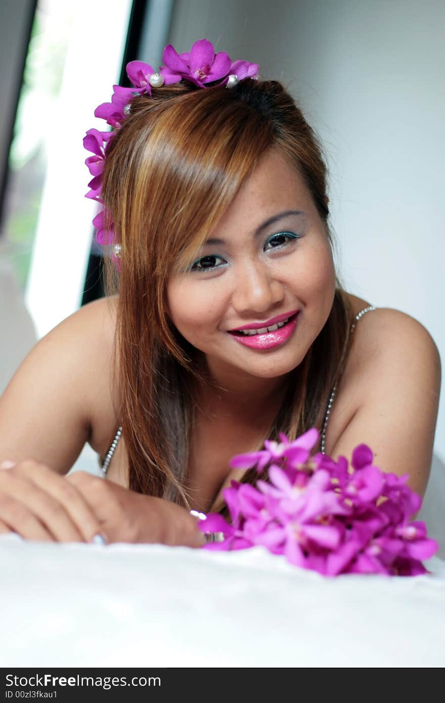 Portrait of a beautiful Asian bride with flowers in her hair.