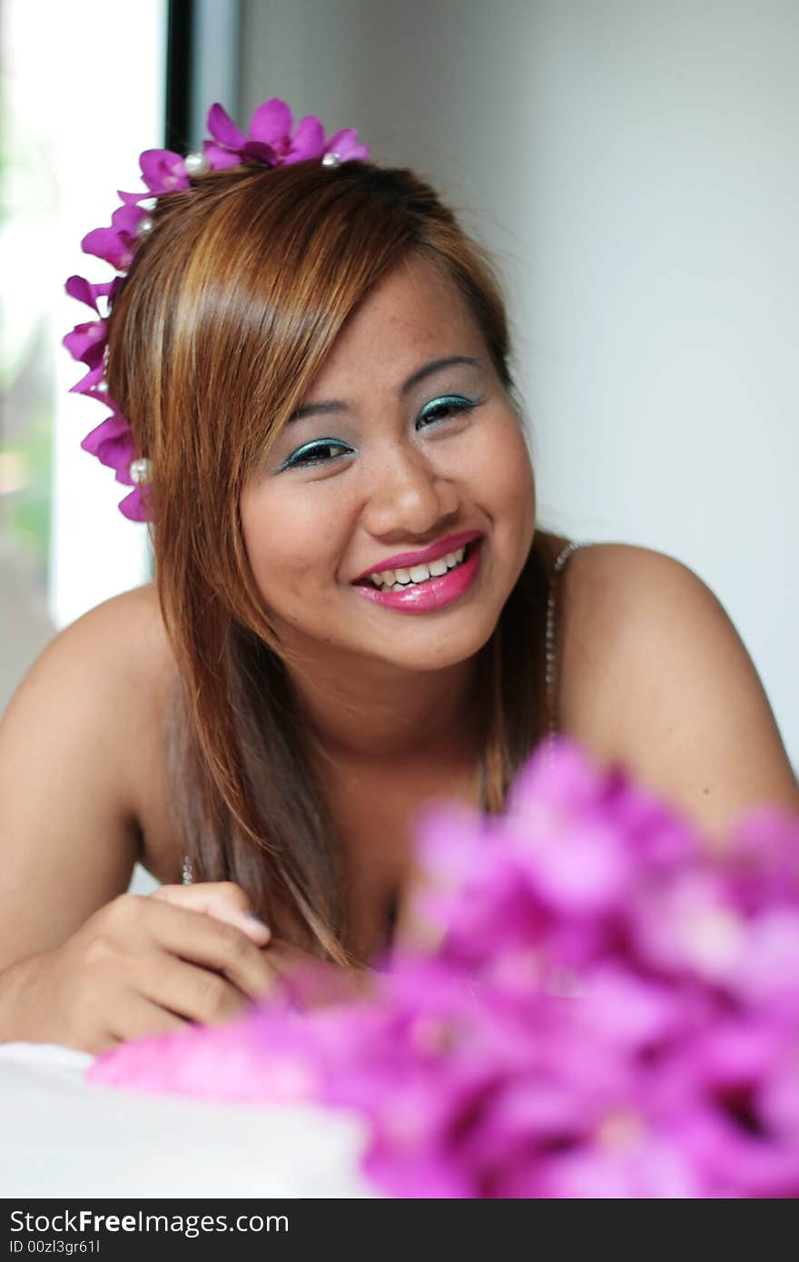 Portrait of a beautiful Asian bride with flowers in her hair.