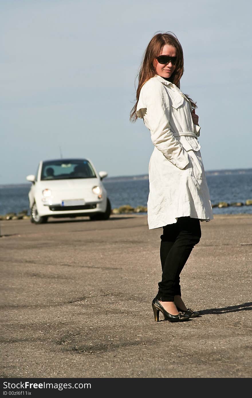 Young lady posing near a car