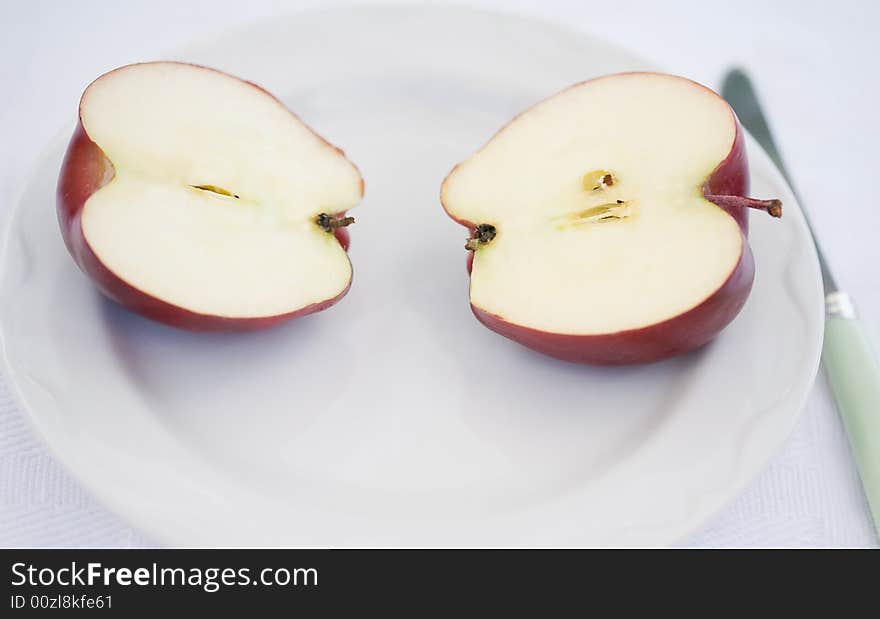 An Apple Sliced in Half on a Plate