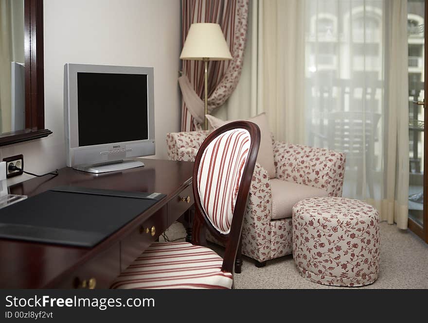 Interior of a modern hotel room with furniture.