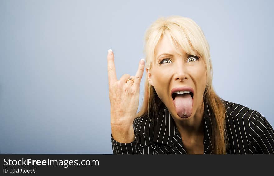 Businesswoman making bull horns