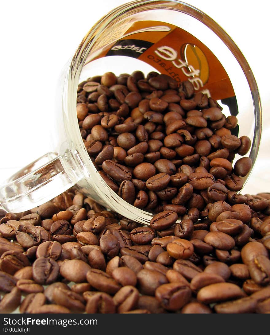 Coffee beans and cup of coffe on white background