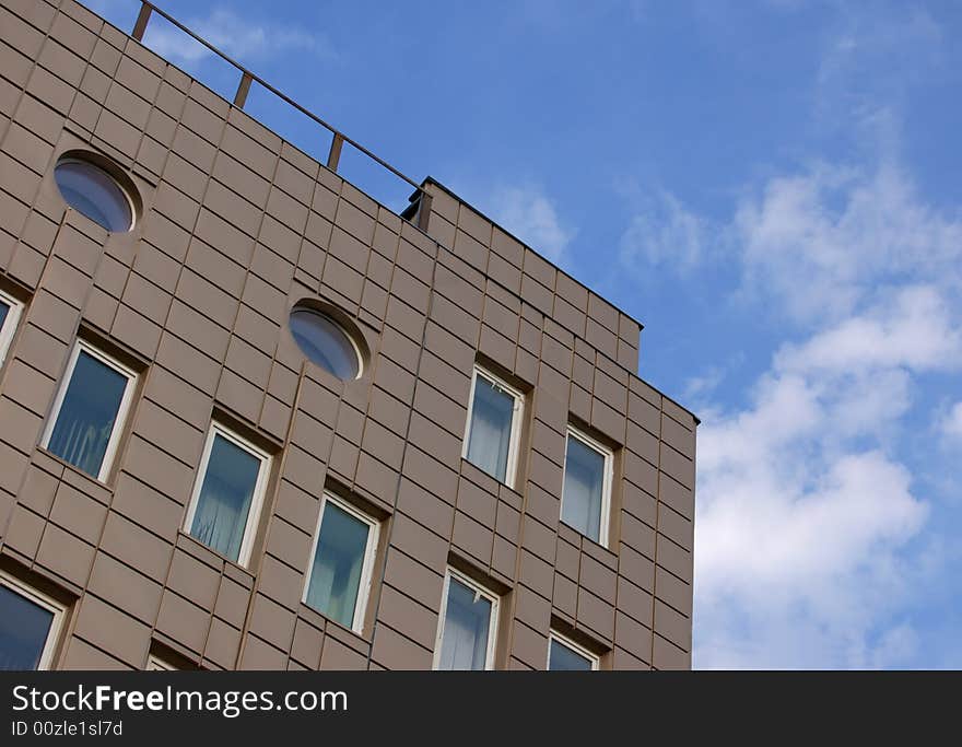 Modern office building over blue sky with clouds. Modern office building over blue sky with clouds