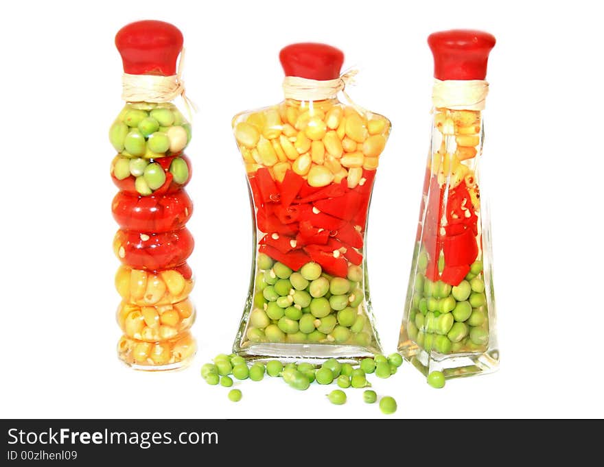 Set - corn, pepper and peas in glass bank on a white background