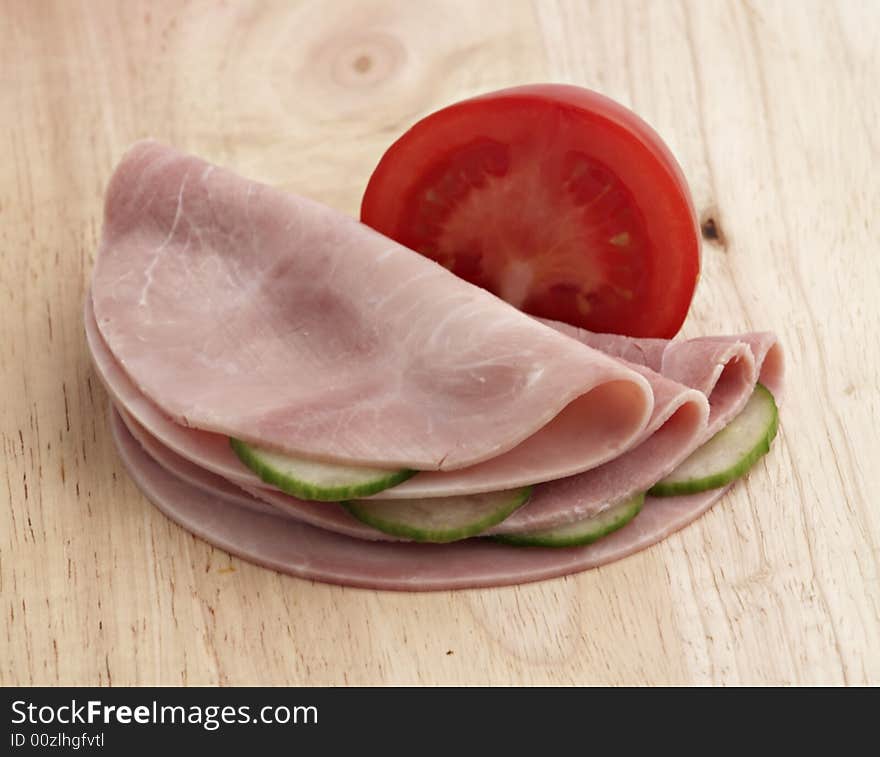 Ham With Vegetables On Wooden Board