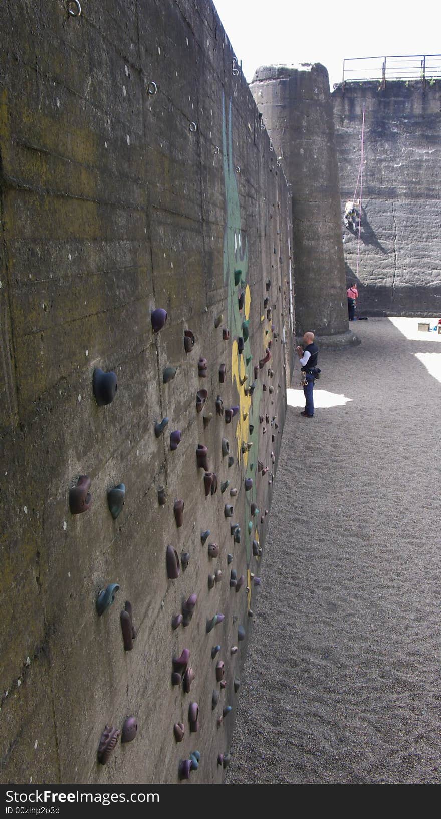 People practicing rock climbing at an old industrial building