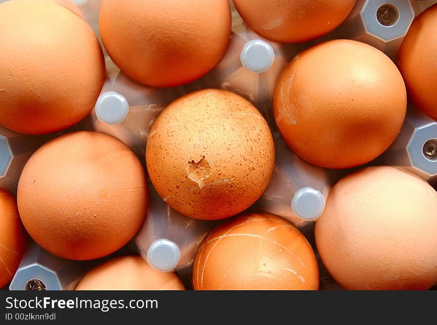 A set of brown eggs in a plastic tray. A set of brown eggs in a plastic tray