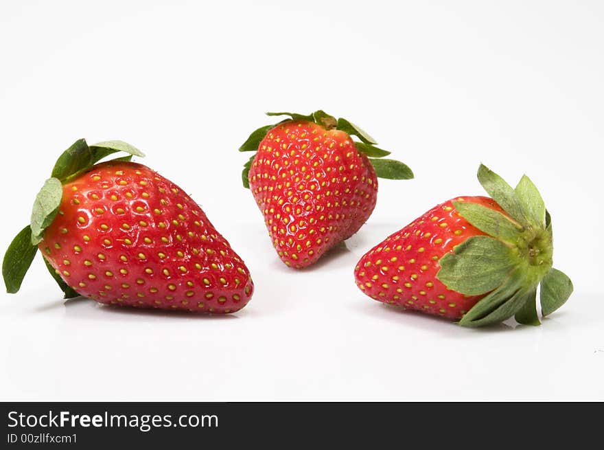 Closeup of three large juicy red strawberries on white background. Closeup of three large juicy red strawberries on white background