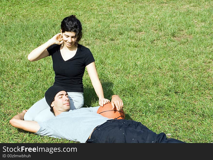 Man Holding Basketball with Woman in Grass - Hori