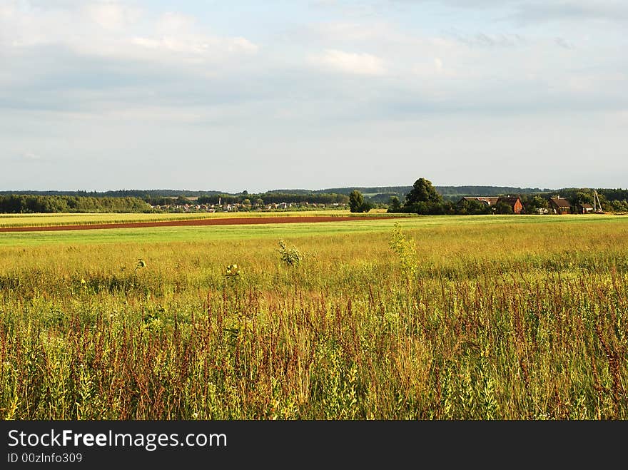 The countryside field filled with sunset light in Lithuania. The countryside field filled with sunset light in Lithuania.