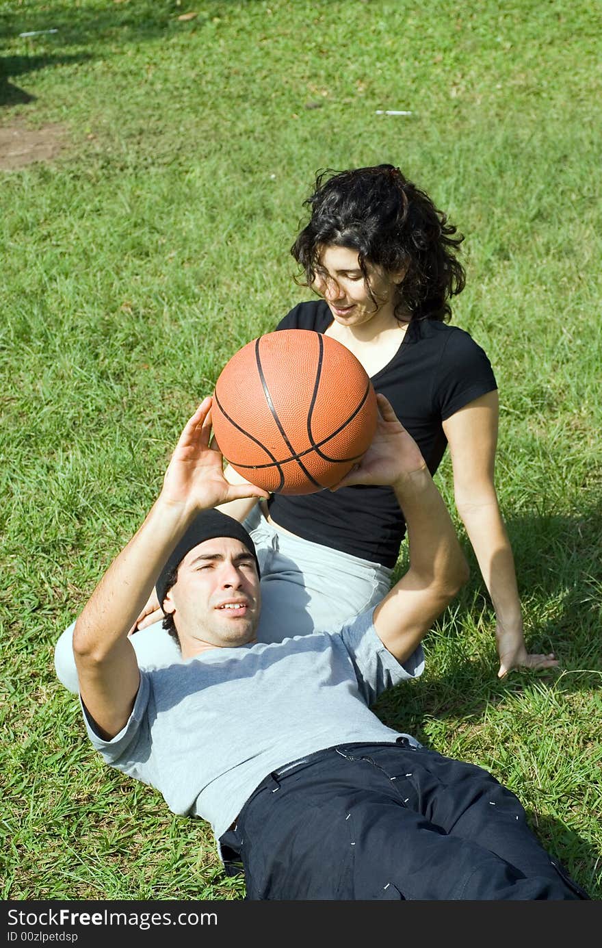 Man Holding Basketball Sitting with Woman