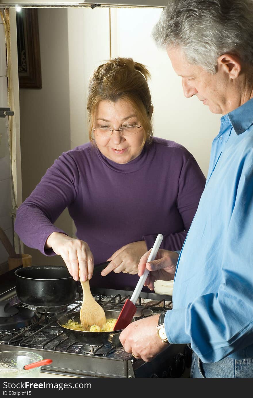 Couple Making Scrambled Eggs - Vertical