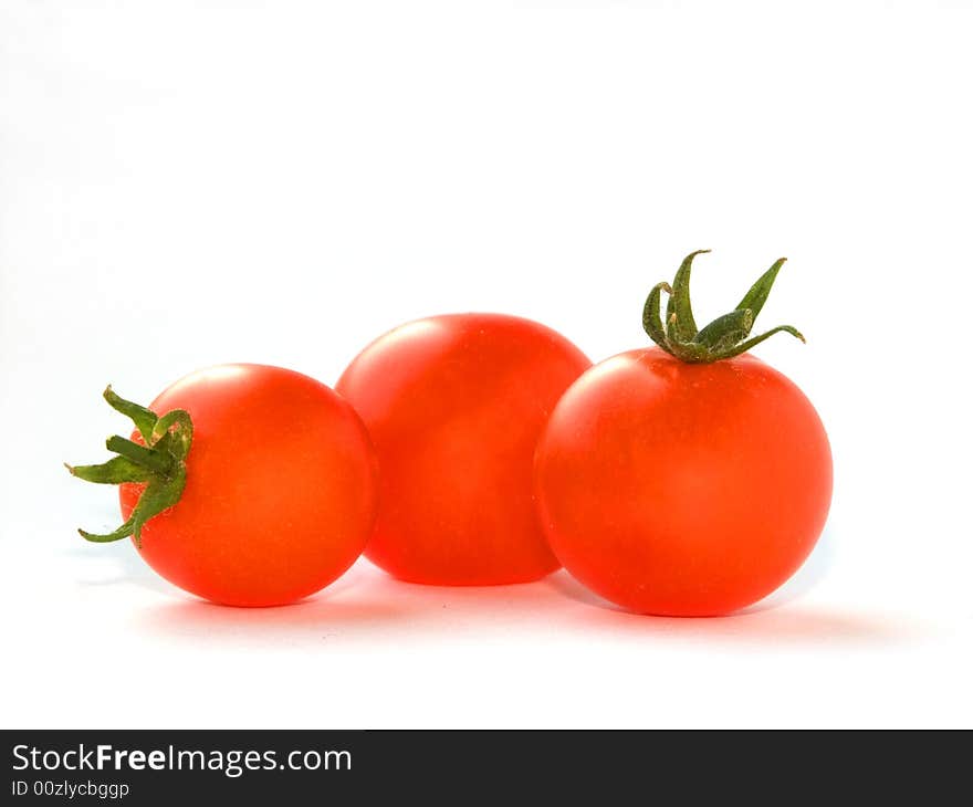 Ripe tomatoes on white background