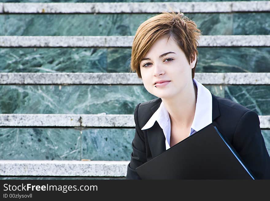 Smiling businessman over marble steps background. Smiling businessman over marble steps background.