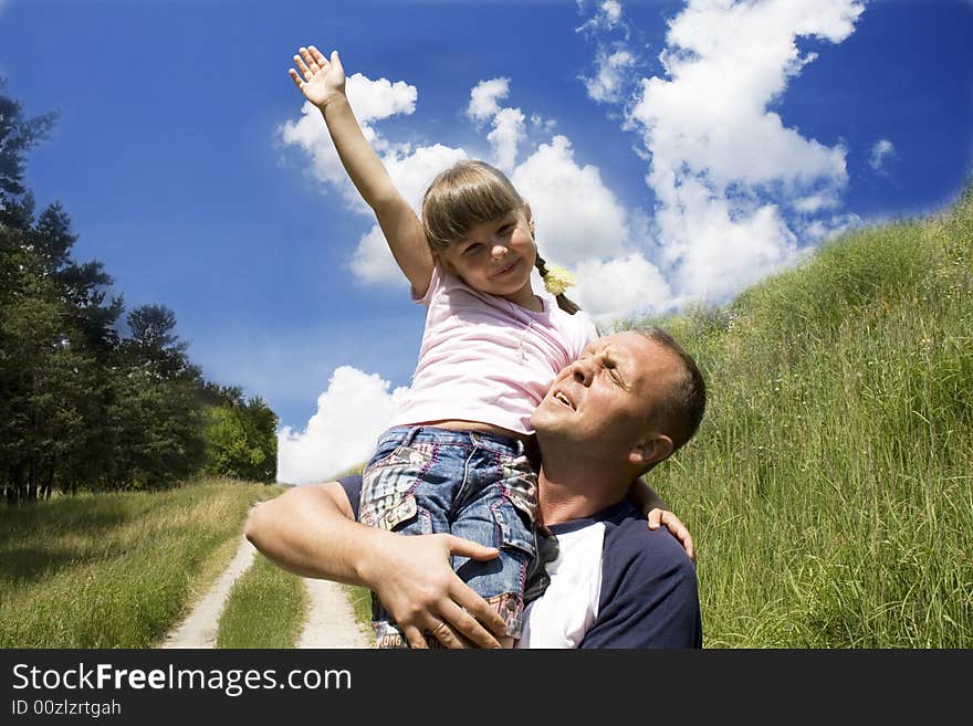 The father and the daughter against the sky. The father and the daughter against the sky