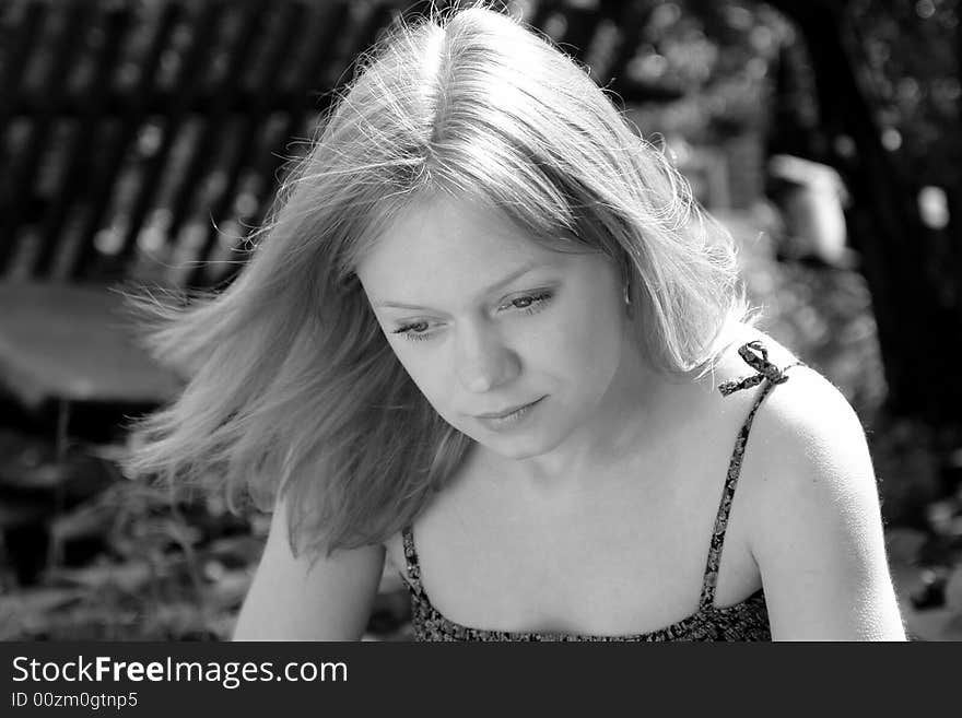 Natural portrait of a thoughtful beautiful girl over pastoral scene. Natural portrait of a thoughtful beautiful girl over pastoral scene