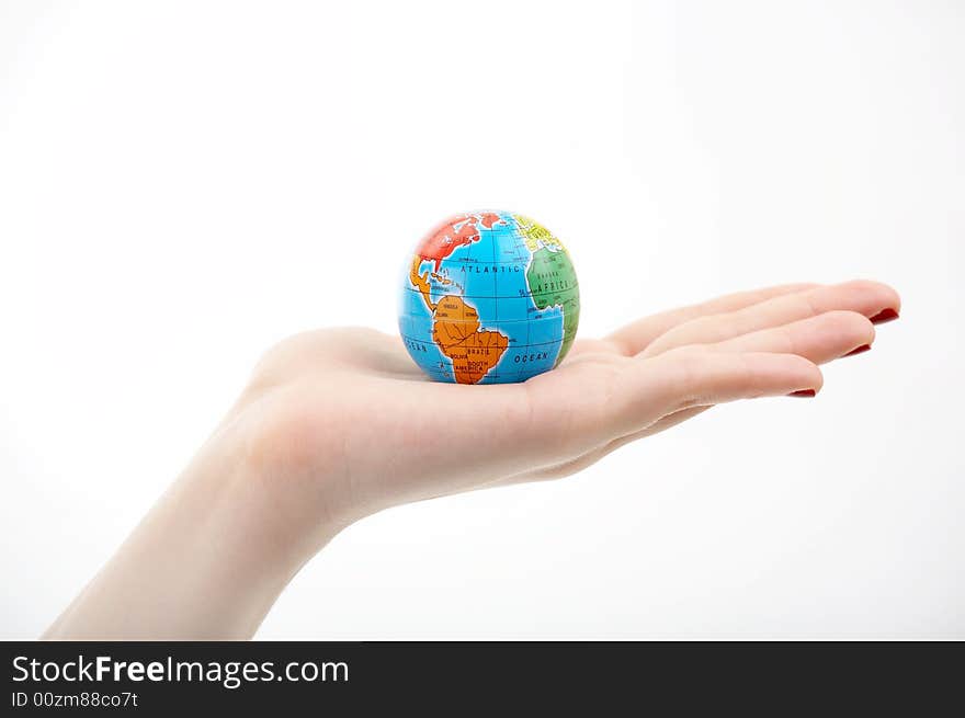 The globe in a hand on a white background. The globe in a hand on a white background