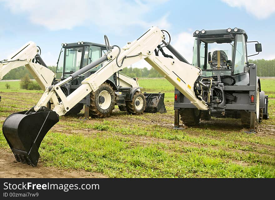 Two modern excavators on the field. Two modern excavators on the field