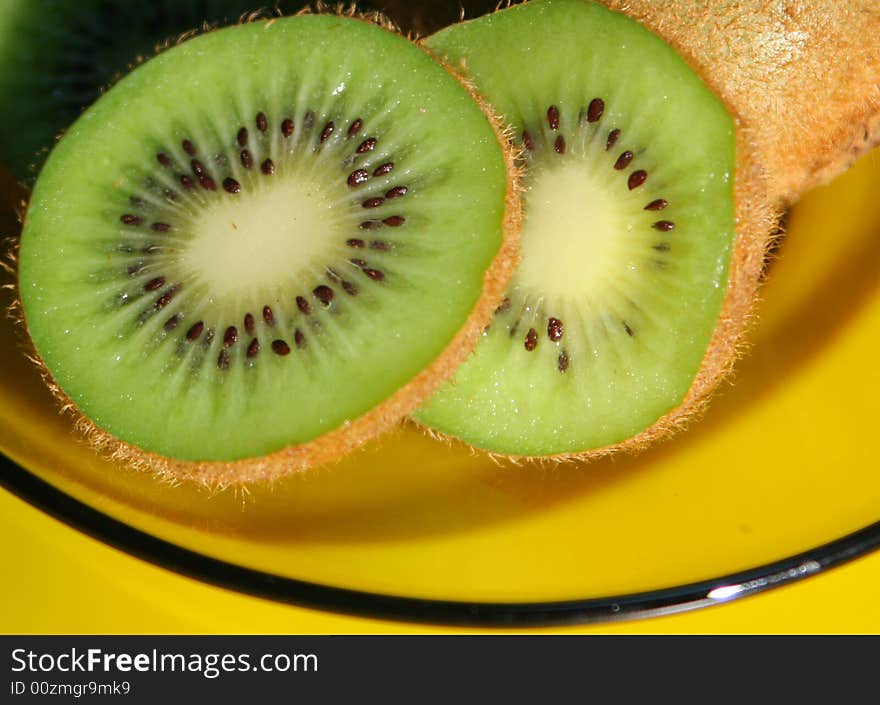 Slices of kiwi cut in glass plate. Slices of kiwi cut in glass plate