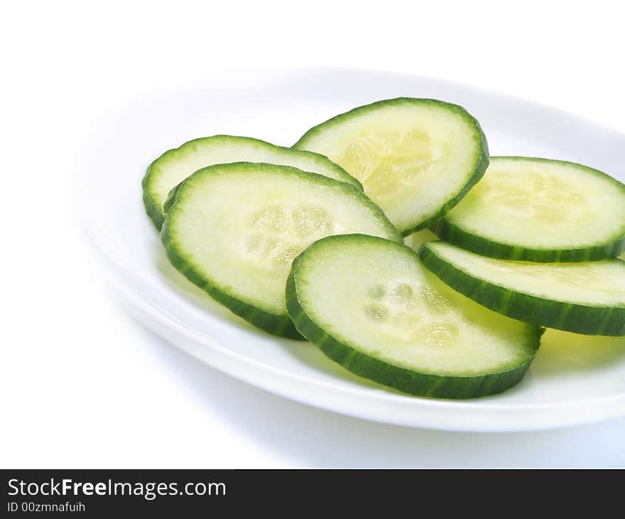 Fresh sliced cucumber on a white plate. Fresh sliced cucumber on a white plate