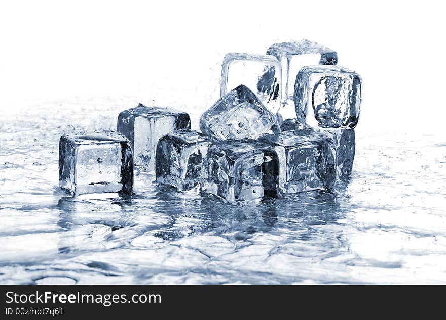 Melting ice cubes in water on white background