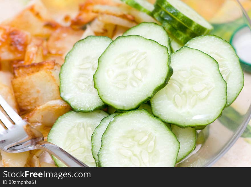 Potato and cucumber on a glass plate. Potato and cucumber on a glass plate