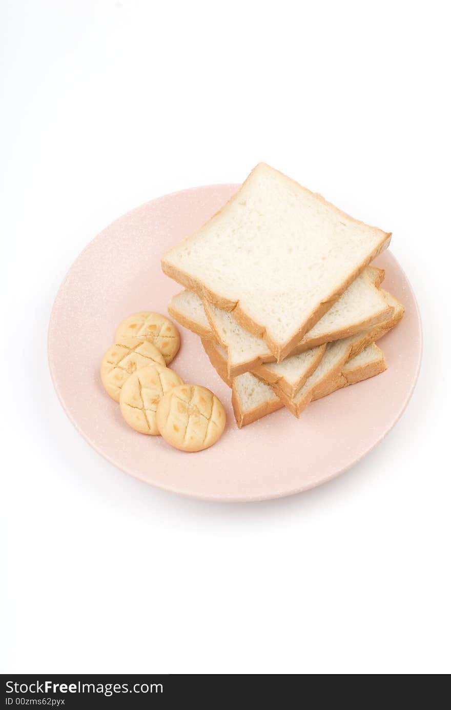 Toast and cookies in the plate with white background.