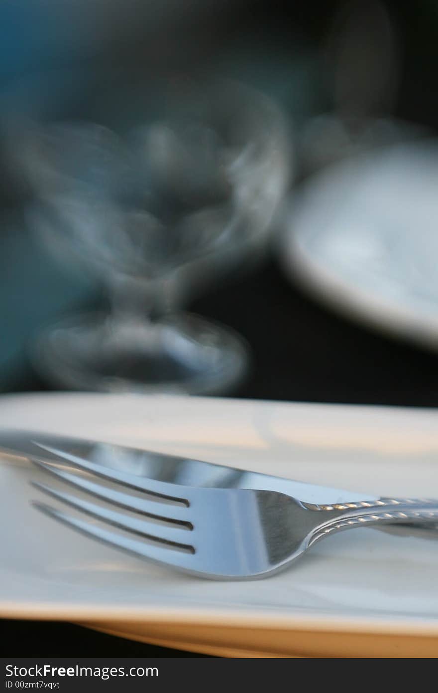 A detail shot of a fork on a dinner table