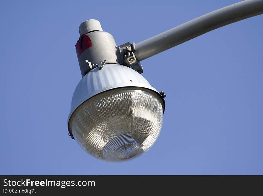 Macro close-up of urban style lantern with blue sky