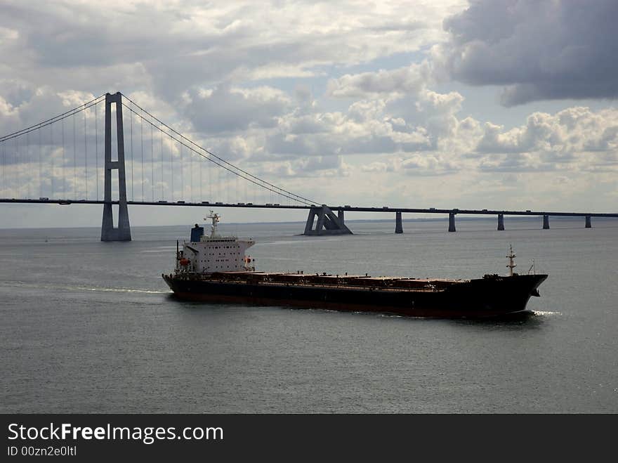 Cargo ship, having just passed under a bridge